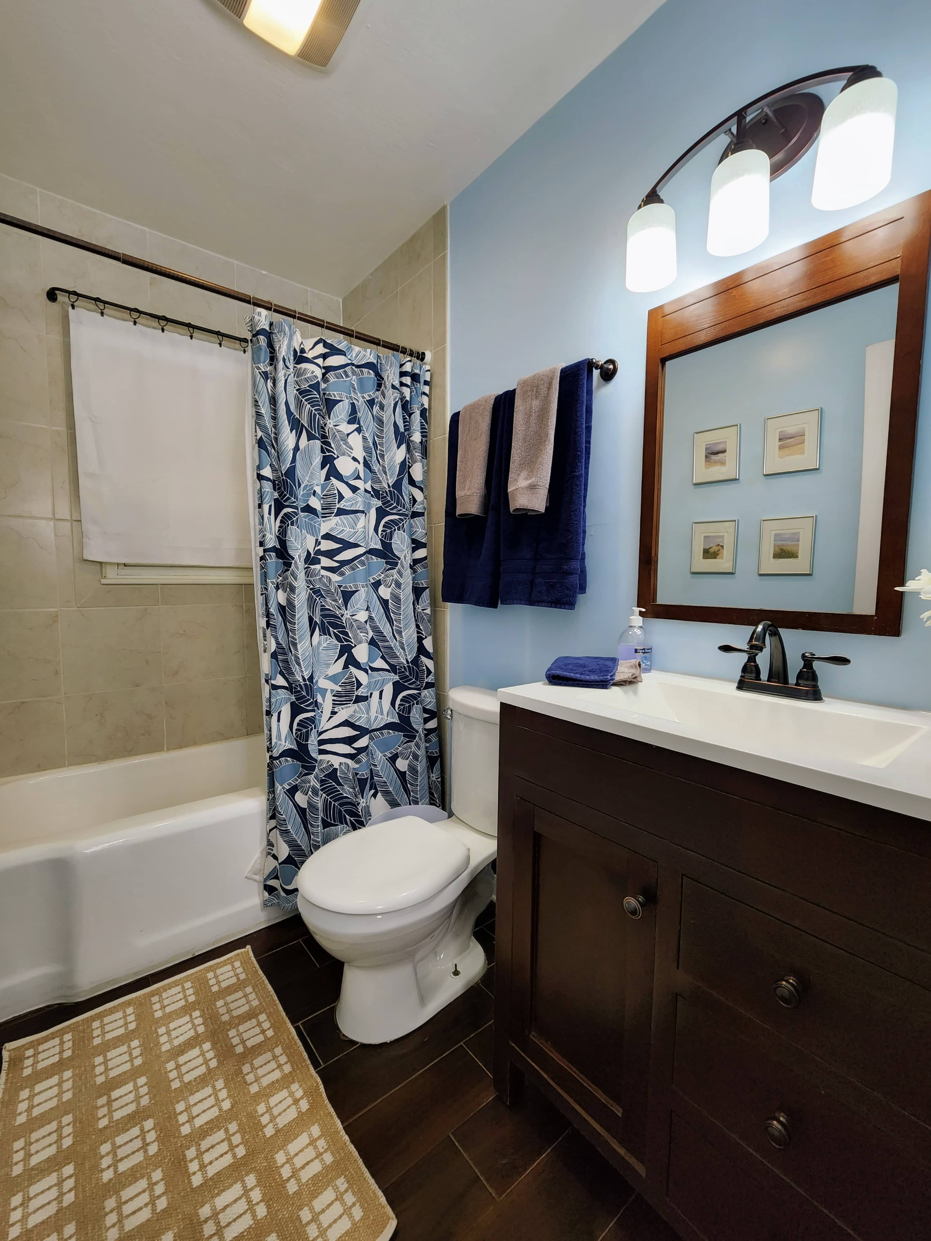 Full bathroom with tub and shower, elegantly designed