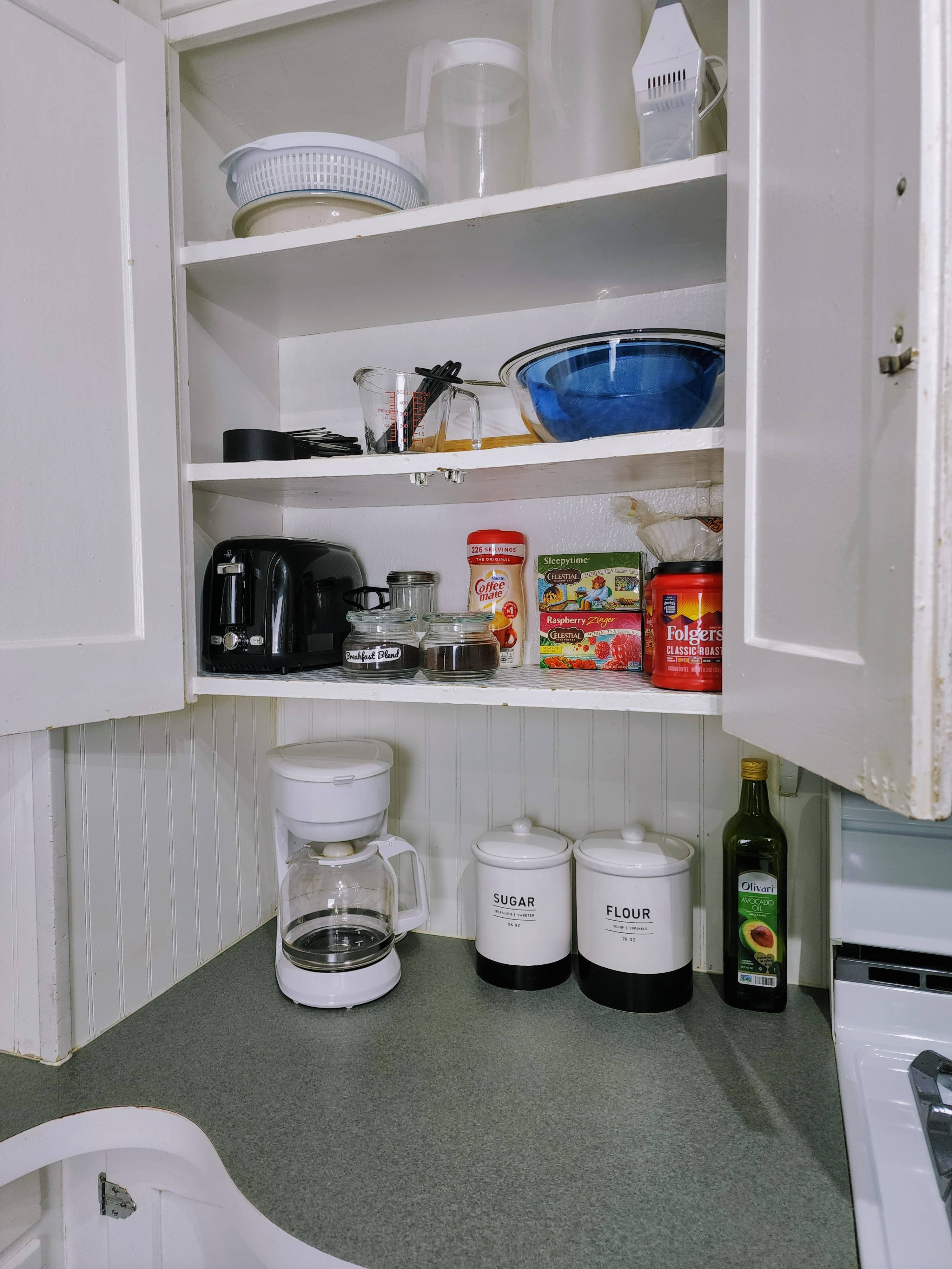 Fully stocked kitchen with lots of appliances, including coffee maker and Keurig