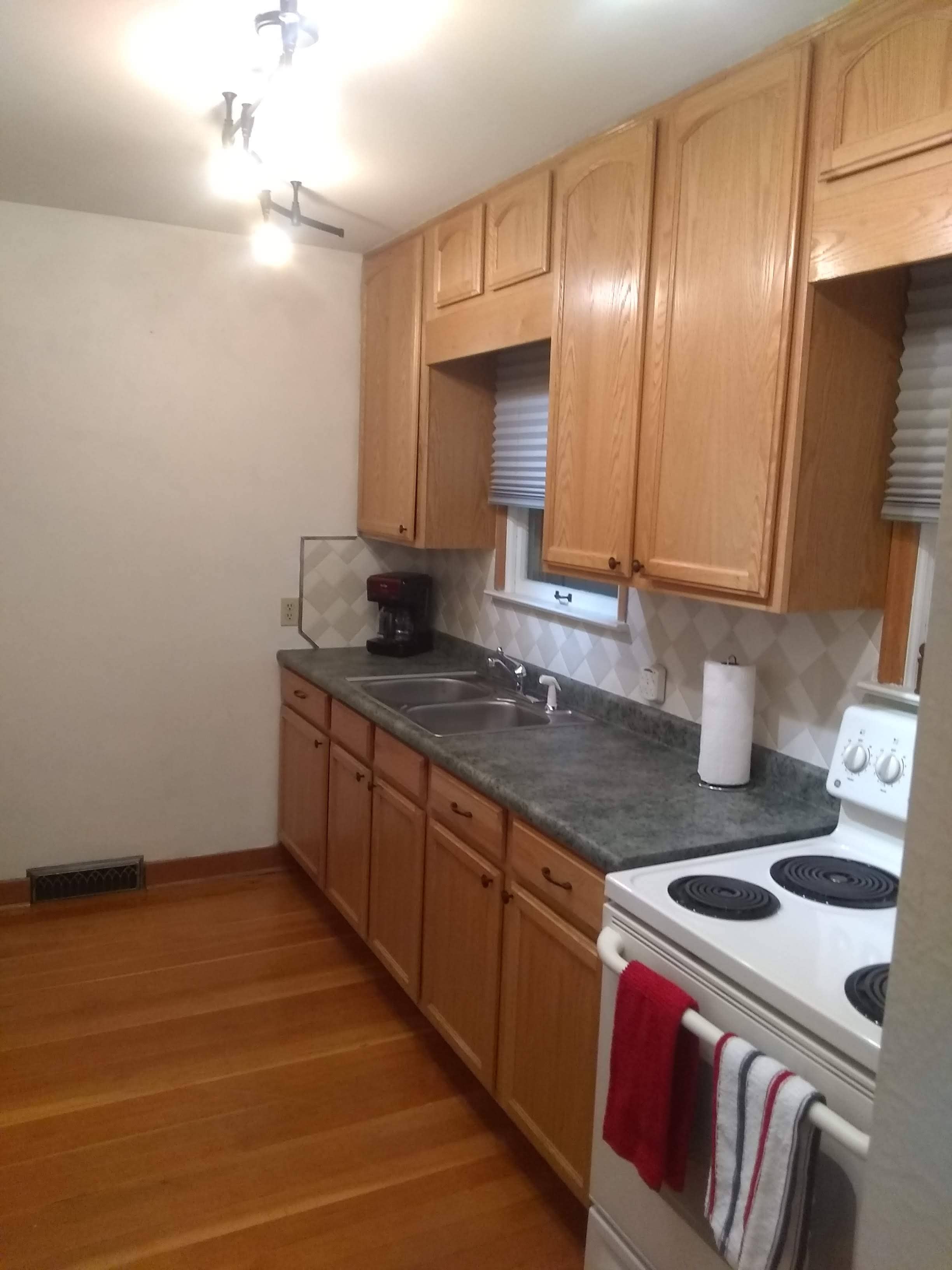 Kitchen with stove, sink, and counters