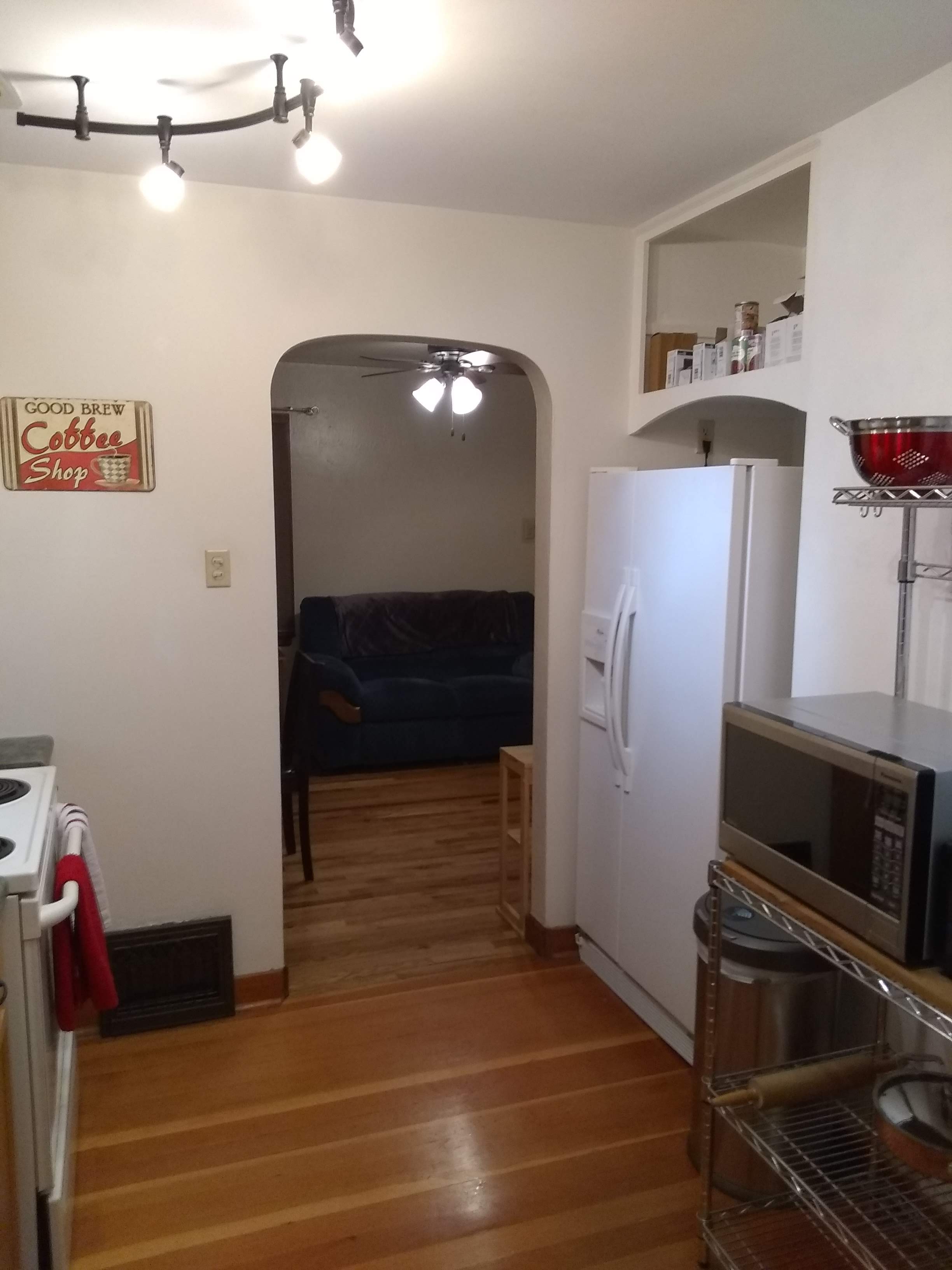 Microwave and fridge on hardwood floors