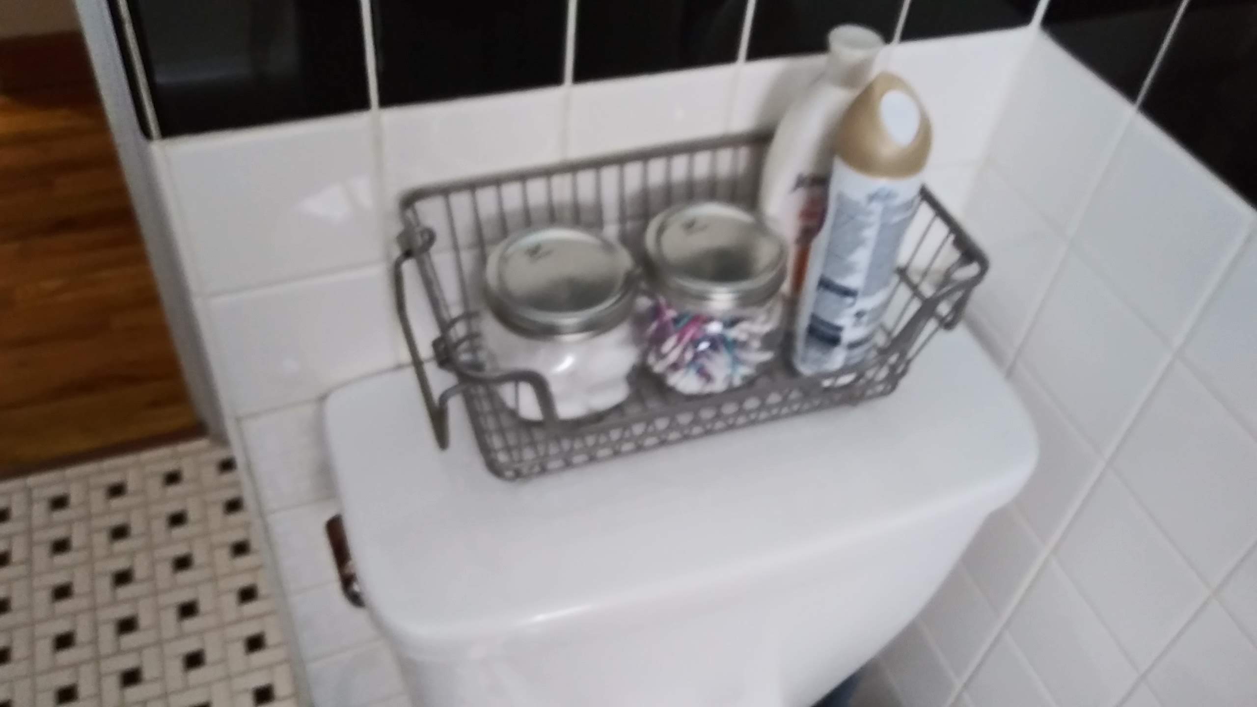 Decorative tray above toilet with candles and decorative items