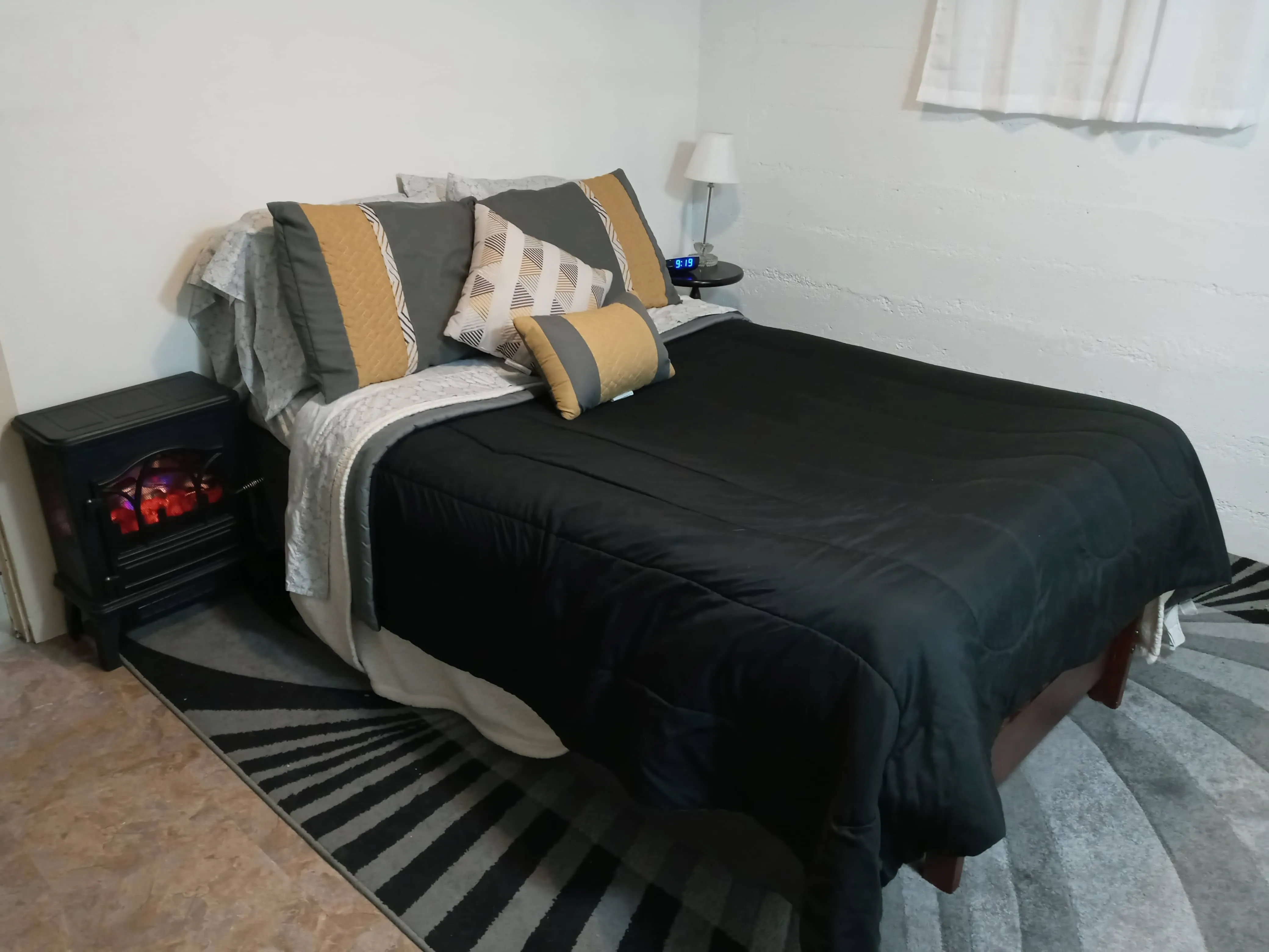 Stylish queen bed with elegant bedding