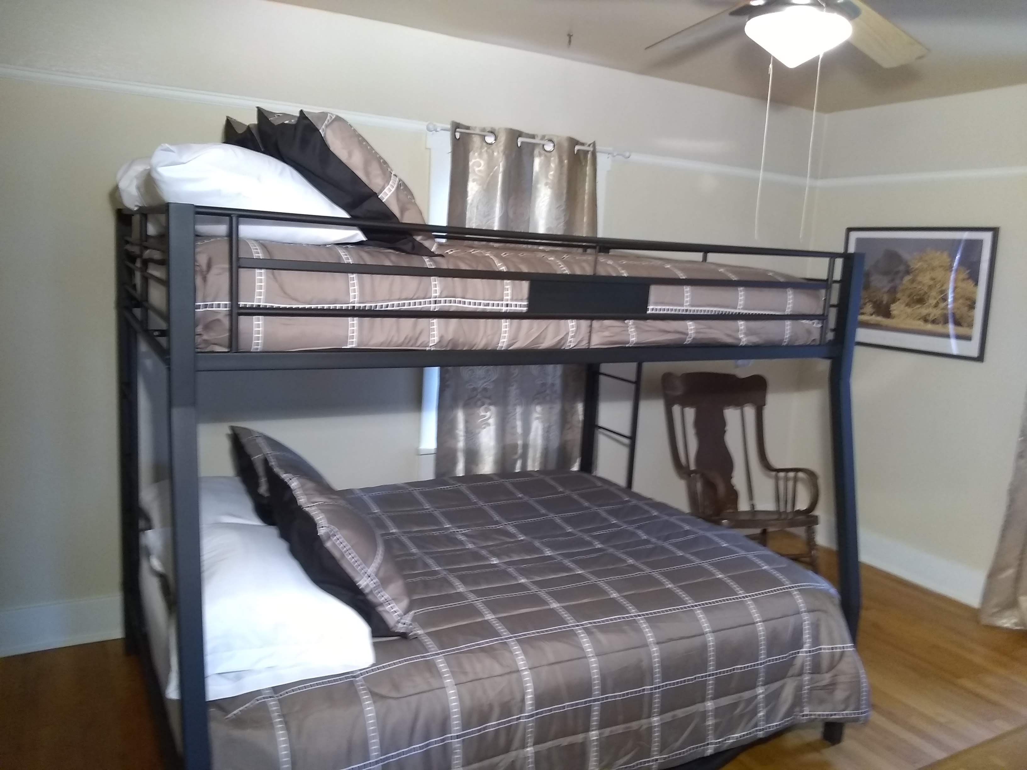 Large room with hardwood floor and bunk bed