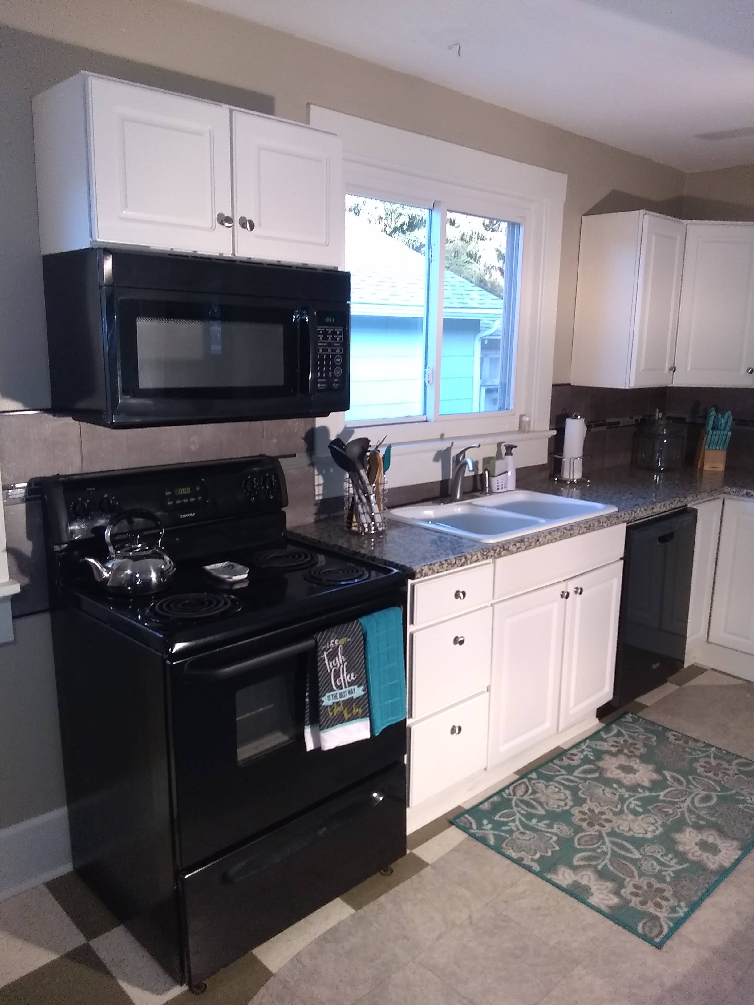 Kitchen with sink, fridge, oven, and dishwasher